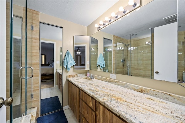 2626 2nd Ct, Palm Harbor, FL 34684 - full bath with connected bathroom, tile patterned flooring, a stall shower, vanity, and a textured ceiling