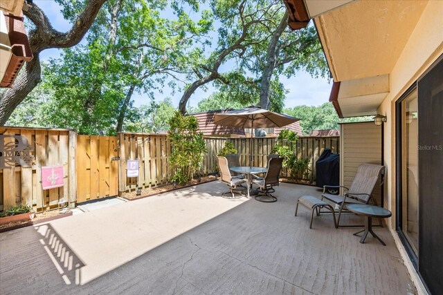 2626 2nd Ct, Palm Harbor, FL 34684 - view of patio with outdoor dining space, fence, and a gate