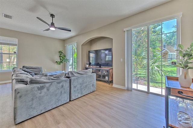 living area featuring ceiling fan, wood finished floors, and baseboards
