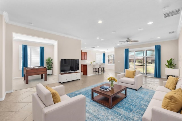 living area featuring light tile patterned floors, ornamental molding, baseboards, and recessed lighting