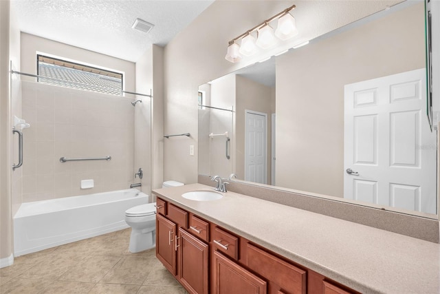bathroom with toilet, vanity, bathtub / shower combination, tile patterned flooring, and a textured ceiling