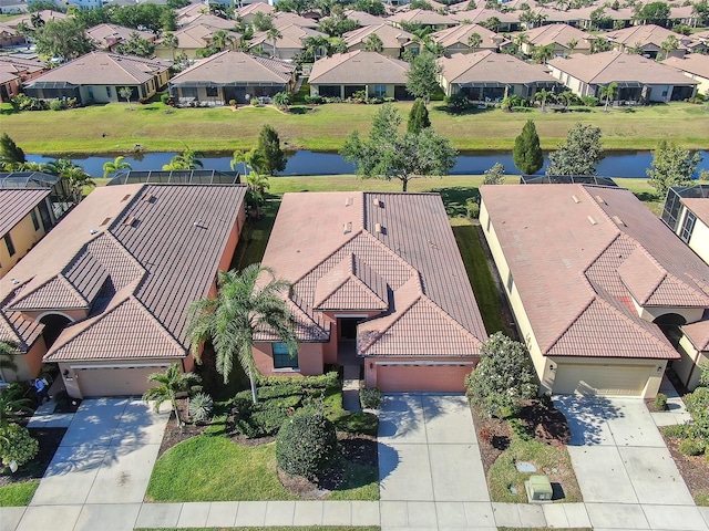 aerial view of residential area featuring a nearby body of water
