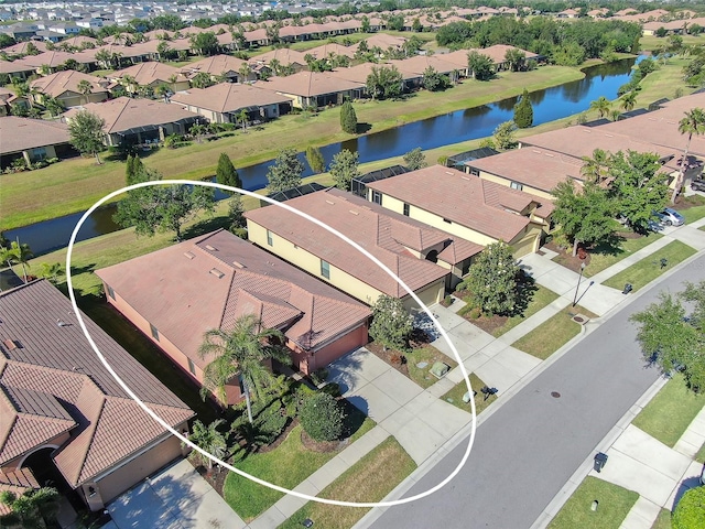 aerial perspective of suburban area with a nearby body of water
