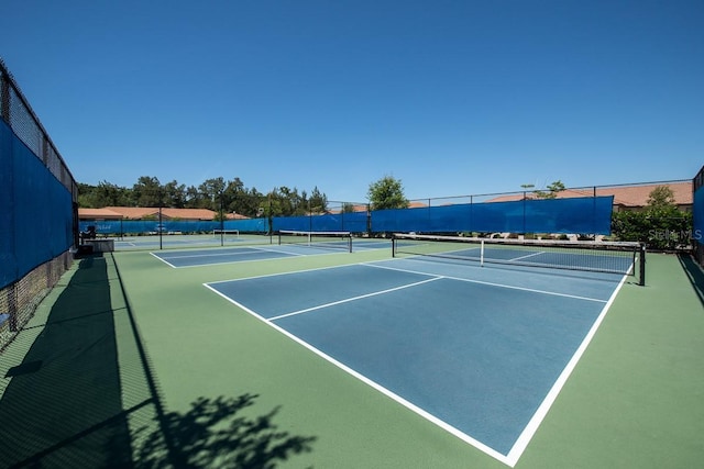 view of tennis court featuring fence