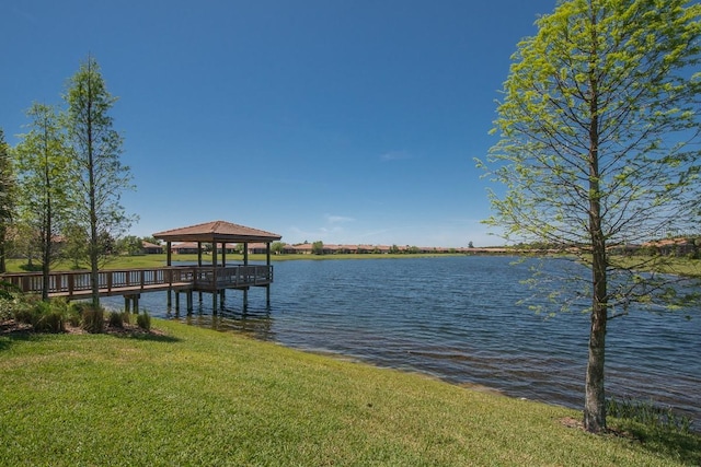 dock featuring a lawn, a water view, and a gazebo