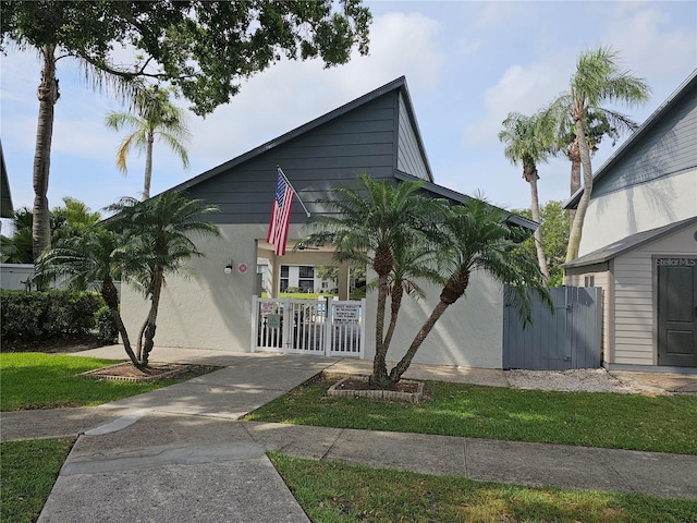 view of side of property featuring fence and a gate