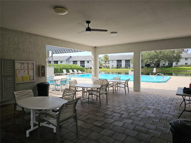 view of patio / terrace with a community pool and ceiling fan