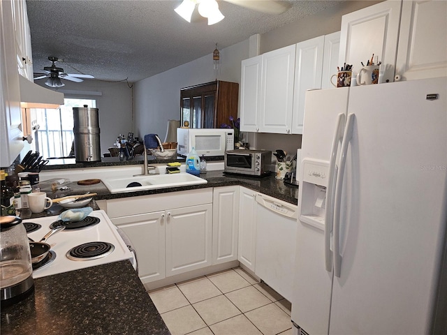 kitchen featuring white appliances, a ceiling fan, a textured ceiling, white cabinetry, and light tile patterned flooring