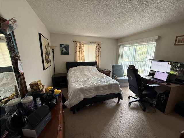 bedroom with carpet, a textured ceiling, and an office area