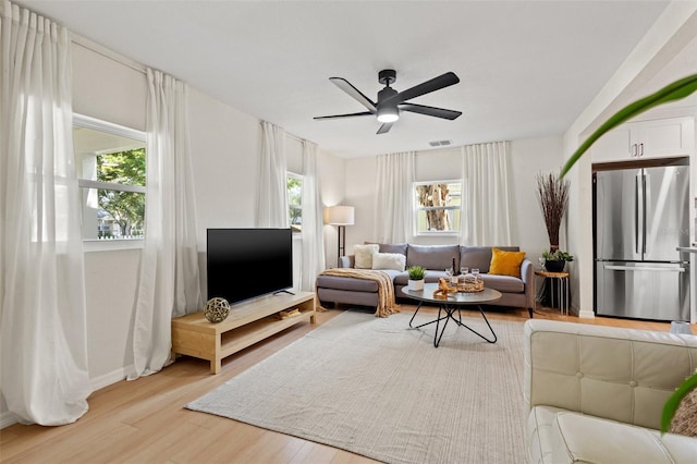 5724 Dr Martin Luther King Jr St N Unit J, Saint Petersburg, FL 33703 - living room with light wood-style flooring, ceiling fan, and baseboards