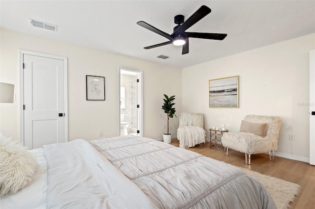 5724 Dr Martin Luther King Jr St N Unit J, Saint Petersburg, FL 33703 - bedroom with wood finished floors, baseboards, ensuite bath, and a ceiling fan
