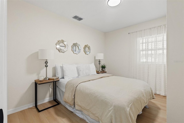 5724 Dr Martin Luther King Jr St N Unit J, Saint Petersburg, FL 33703 - bedroom featuring light wood-type flooring and baseboards