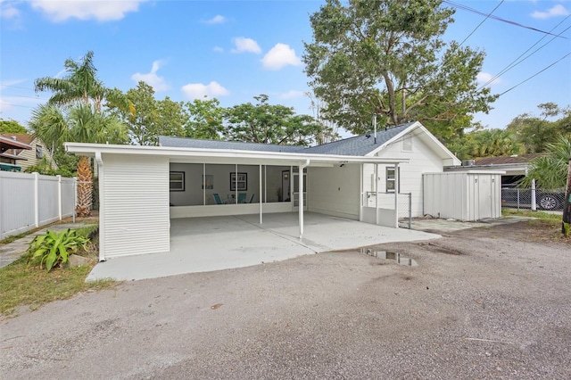 5724 Dr Martin Luther King Jr St N Unit J, Saint Petersburg, FL 33703 - rear view of property with fence and an attached carport