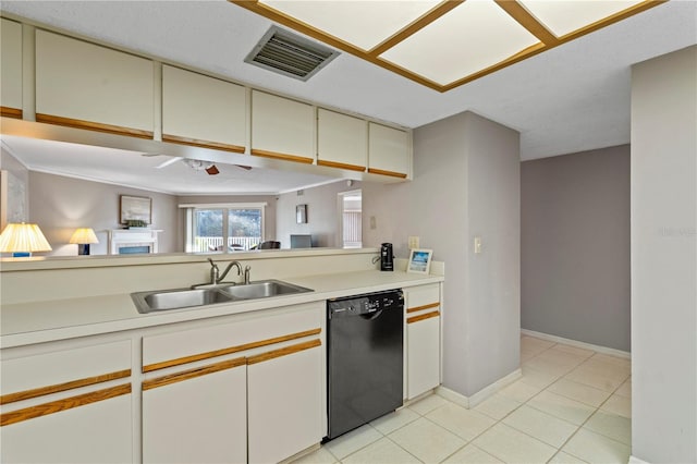 18400 Gulf Blvd Unit 1105, Indian Shores, FL 33785 - kitchen with black dishwasher, a sink, light countertops, and light tile patterned floors