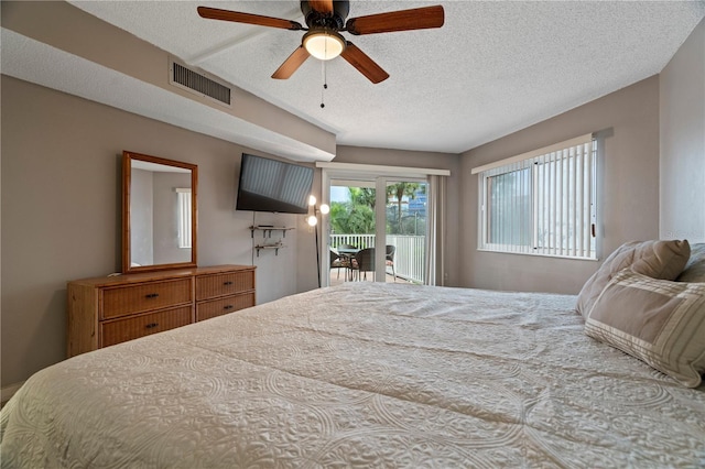18400 Gulf Blvd Unit 1105, Indian Shores, FL 33785 - bedroom featuring access to exterior, a textured ceiling, and ceiling fan
