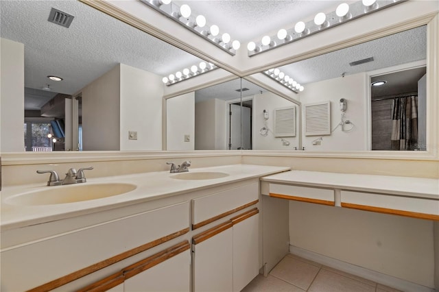 18400 Gulf Blvd Unit 1105, Indian Shores, FL 33785 - bathroom with a textured ceiling, tile patterned floors, and double vanity
