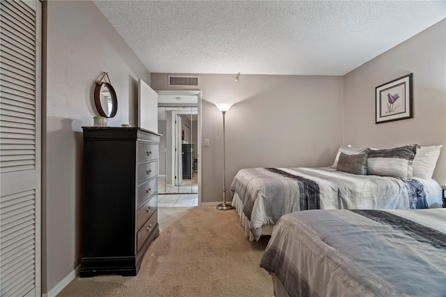18400 Gulf Blvd Unit 1105, Indian Shores, FL 33785 - bedroom featuring light carpet, a textured ceiling, and baseboards