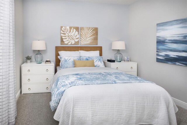 carpeted bedroom featuring baseboards
