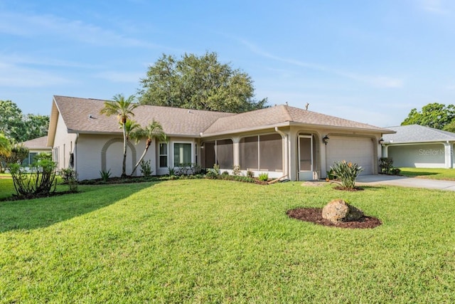 ranch-style house with a sunroom, a garage, a front lawn, and driveway