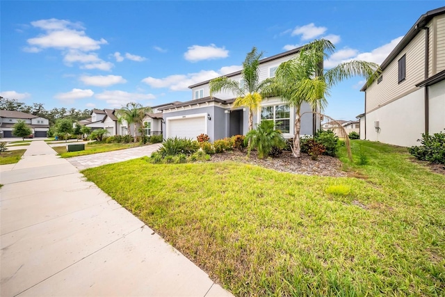 view of front of house featuring a front lawn, driveway, a garage, a residential view, and stucco siding