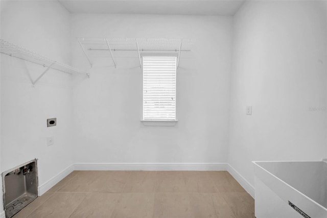 laundry area with hookup for an electric dryer and baseboards