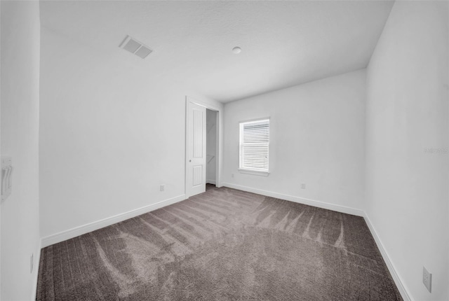 carpeted spare room with baseboards