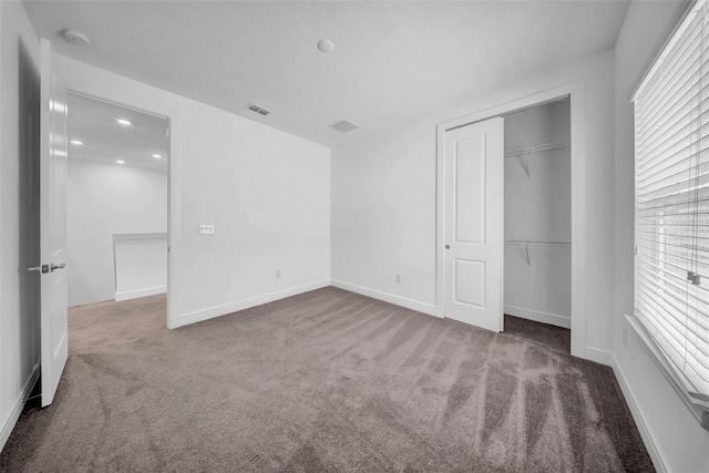 unfurnished bedroom featuring carpet floors, a closet, and baseboards