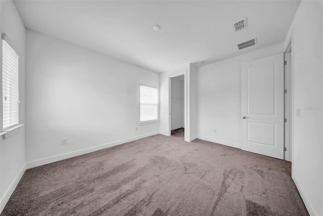 unfurnished bedroom featuring carpet flooring and baseboards