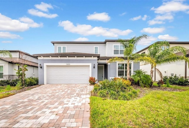 13855 Sharp Hawk Dr, Riverview, FL 33569 - view of front facade featuring decorative driveway, an attached garage, stucco siding, and a front lawn