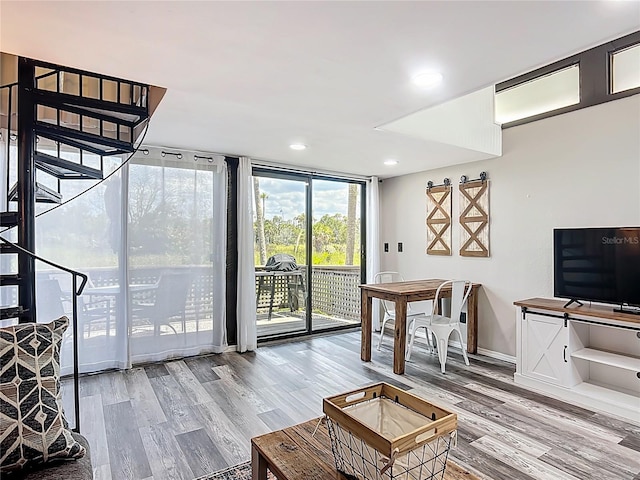 2653 N Seabreeze Pt Unit M-2, Crystal River, FL 34429 - living room with wood finished floors, stairway, baseboards, recessed lighting, and expansive windows