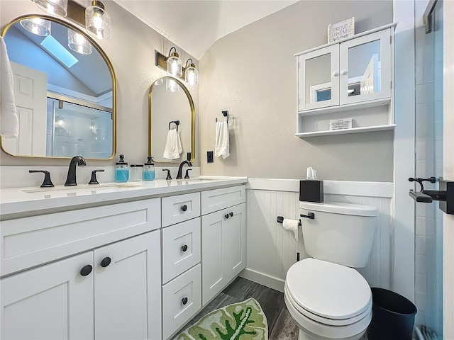 2653 N Seabreeze Pt Unit M-2, Crystal River, FL 34429 - full bath with toilet, a shower stall, wainscoting, double vanity, and wood finished floors