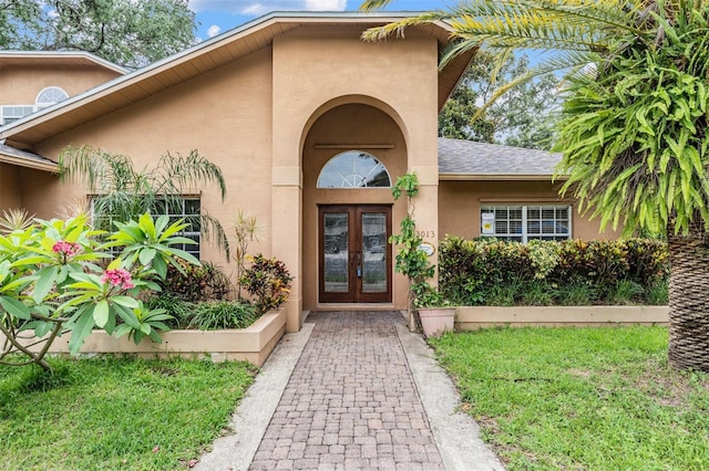 3013 Crest Dr, Clearwater, FL 33759 - view of exterior entry with french doors and stucco siding
