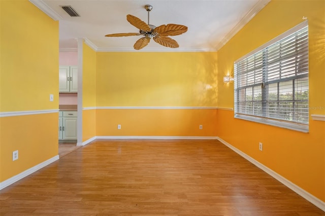 3013 Crest Dr, Clearwater, FL 33759 - spare room featuring a ceiling fan, light wood-style flooring, ornamental molding, and baseboards