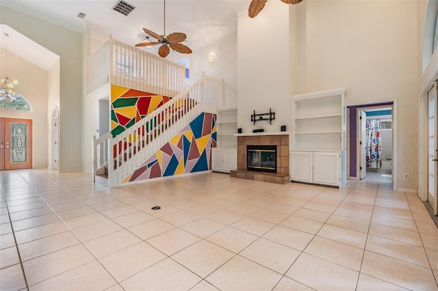 3013 Crest Dr, Clearwater, FL 33759 - unfurnished living room featuring a high ceiling, light tile patterned flooring, ceiling fan, a fireplace, and baseboards