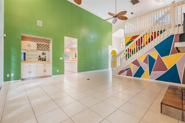 3013 Crest Dr, Clearwater, FL 33759 - unfurnished living room featuring a high ceiling, light tile patterned floors, ceiling fan, and baseboards