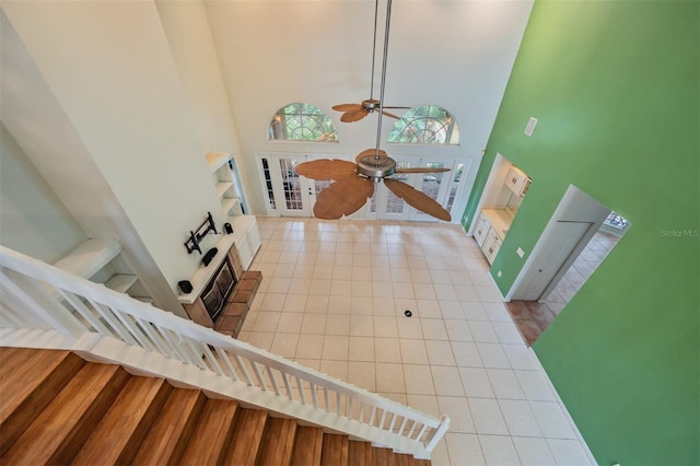 3013 Crest Dr, Clearwater, FL 33759 - stairway featuring a high ceiling, tile patterned flooring, and ceiling fan