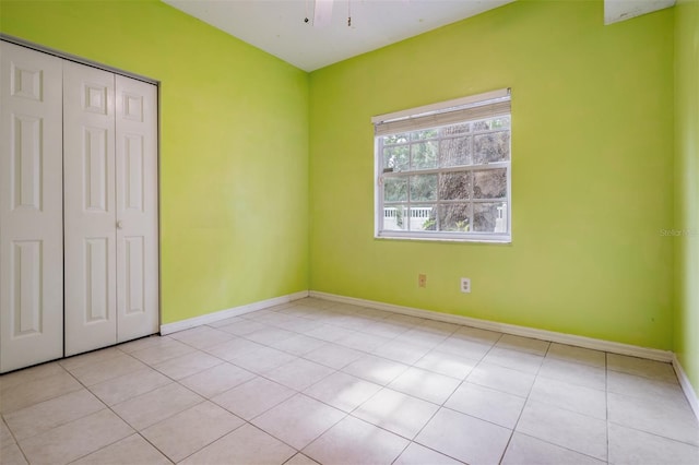 3013 Crest Dr, Clearwater, FL 33759 - unfurnished bedroom with tile patterned floors, a closet, and baseboards