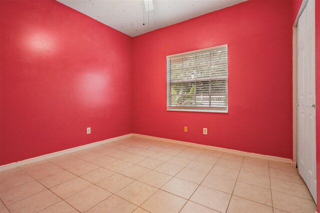 3013 Crest Dr, Clearwater, FL 33759 - empty room featuring light tile patterned floors, a ceiling fan, and baseboards