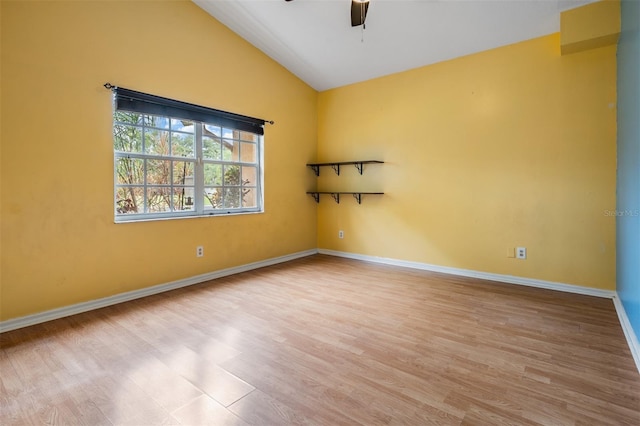3013 Crest Dr, Clearwater, FL 33759 - spare room featuring a ceiling fan, vaulted ceiling, wood finished floors, and baseboards