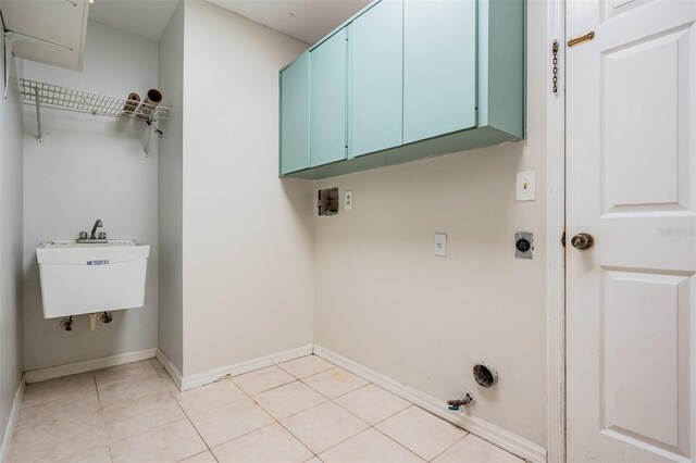 3013 Crest Dr, Clearwater, FL 33759 - washroom featuring cabinet space, light tile patterned floors, baseboards, and hookup for a washing machine