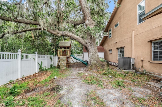 3013 Crest Dr, Clearwater, FL 33759 - view of yard with cooling unit and a playground