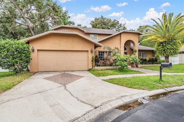 3013 Crest Dr, Clearwater, FL 33759 - view of front of property featuring stucco siding, driveway, an attached garage, and a front lawn