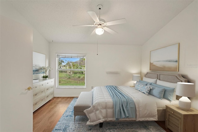bedroom with wood finished floors, ceiling fan, and vaulted ceiling
