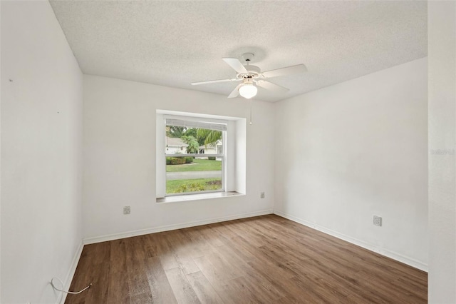 unfurnished room featuring wood finished floors, a textured ceiling, ceiling fan, and baseboards