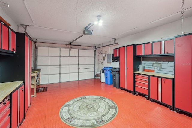 garage with a garage door opener and electric panel