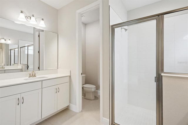 full bath with a stall shower, toilet, vanity, and tile patterned floors