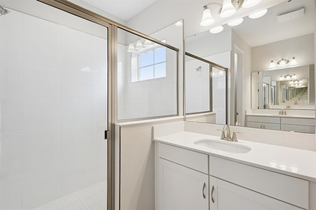 full bathroom featuring a stall shower and vanity