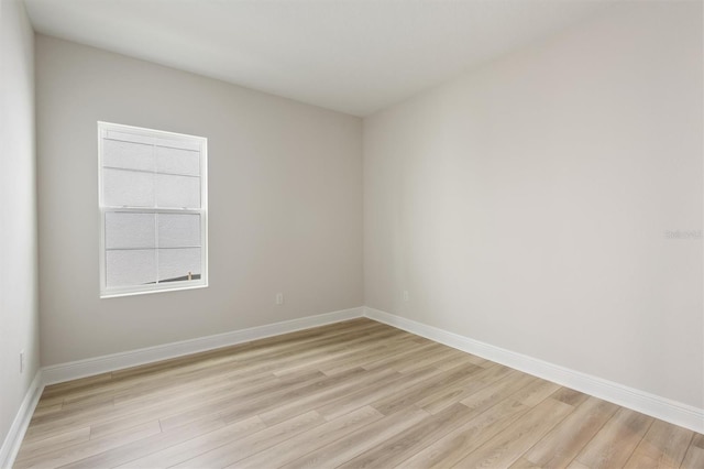 empty room with light wood-style floors and baseboards