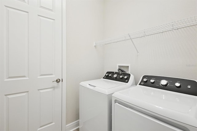 clothes washing area featuring separate washer and dryer