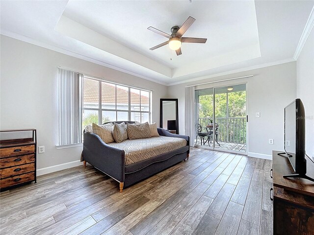 18001 Richmond Place Dr Unit 330, Tampa, FL 33647 - bedroom featuring a raised ceiling, access to outside, wood finished floors, baseboards, and ornamental molding